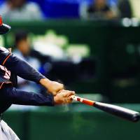 Having a blast: Jonathan Schoop of the Netherlands strokes a three-run homer against Cuba on Friday in the sixth inning of their World Baseball Classic second-round game at Tokyo Dome. The Dutch downed the Cubans 6-2. | AP