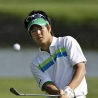 Work time: Ryo Ishikawa chips to the third green in the third round of the Transitions Championship on Saturday in Palm Harbor, Fla. | AP PHOTO
