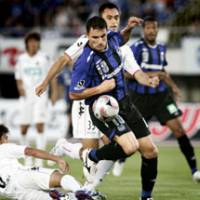 Lethal weapon: Gamba Osaka striker Bare battles for the ball during his side\'s 4-2 win over Consadole Sapporo on Sunday. The win takes Gamba into fourth in the J. League table. | KYODO PHOTO