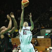 Toshiba guard Takuya Kita scores a layup past Alvark forward Charles O\'Bannon during the semifinals of the All-Japan Basketball Championships on Saturday at Yoyogi National Stadium Annex. With an 86-58 win over the Brave Thunders, defending champion Toyota Motors advanced to Monday\'s final. | KAZ NAGATSUKA PHOTO