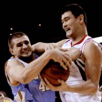 Up close and personal: Denver\'s Linas Kleiza (left) and Houston\'s Yao Ming wrestle for the ball during the Rockets\' 108-96 win on Tuesday. | AP PHOTO