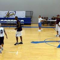 Tuning up: Tokyo Apache coach Bob Hill (front right) watches his charges practice at training camp in Dallas on Monday. The Apache will return to Japan on Sept. 11. | TOKYO APACHE