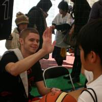 Giving back: Grayson Boucher shares a moment with a young fan during an autograph session in Toyosu. | KAZ NAGATSUKA