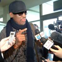 More famous than ever: Former NBA star Dennis Rodman is interviewed by journalists before leaving Pyongyang Airport last week. | AFP-JIJI