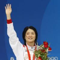 Bronze glory: Reiko Nakamura waves after receiving her medal for a third-place finish in the women\'s 200-meter backstroke on Saturday morning at the Water Cube. | AP PHOTO