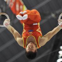 Ring king: Chen Yibing, a three-time world rings champion, performs up to his usual high standards at the world gymnastics championships in Tokyo, but his team fell behind in overall standings, with the Japan men\'s team taking the lead on Monday. | KYODO PHOTO