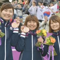 Bullseye: Archers (from left) Ren Hayakawa, Miki Kanie, and Kaori Kawanaka pose with their bronze medals on Sunday. | KYODO