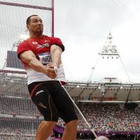 Solid start: Koji Murofushi competes in the qualifying round of the men\'s hammer throw on Friday at the Olympic Stadium. | AP