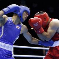Packing a powerful punch: Ryota Murata works over Uzbekistan\'s Abbos Atoev in their middleweight semifinal bout on Friday at ExCel Arena. Murata won a 13-12 decision. | AP