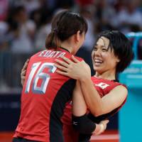 Mission accomplished: Saori Sakoda (right) celebrates with Japan teammate Yukiko Ebata after beating South Korea in straight sets to win the bronze medal at the London Games on Saturday. | AP