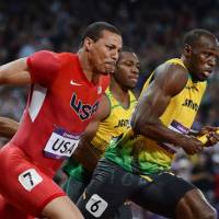 Catch you later: Usain Bolt runs ahead of Ryan Bailey during the men\'s 4x100-meter relay final on Saturday. | AFP-JIJI