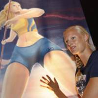 Sweden\'s Carolina Kluft, an Olympic heptathlon champion and two-time gold medalist in the world championships, stands in front of a manga-style illustration of herself in Osaka on Wednesday. Kluft will compete in the 2007 IAAF World Championships, which begin on Saturday. | AP PHOTO