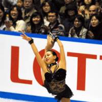 Like a queen: Mao Asada skates during her free program during the NHK Trophy at Yoyogi National Gymnasium on Saturday. Asada won the tournament and clinched a spot in next month\'s Grand Prix Final. | YOSHIAKI MIURA PHOTO