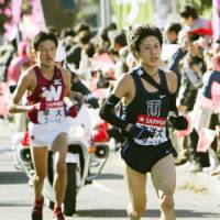 Going for the victory: Toyo University\'s Yu Chiba (right) takes off, leaving Kenji Nakajima of Waseda University behind during the eighth leg of the Tokyo-Hakone Collegiate Ekiden Road Relay on Saturday. Toyo clinched its first title. | KYODO PHOTO