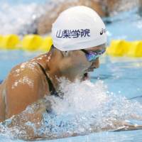 Speedy performance: Satomi Suzuki shatters the Japanese record in the women\'s 100-meter breaststroke at the National Collegiate Swimming Championships on Friday in Kumamoto on Friday. Suzuki finished the race in 1 minute, 6.32 seconds. | KYODO PHOTO