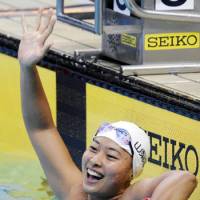 Euphoric moment: Satomi Suzuki celebrates her record-breaking performance in the women\'s 100-meter breaststroke at the National Collegiate Swimming Championships on Friday. | KYODO PHOTO