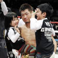 Proud papa: Hozumi Hasegawa, the WBC bantamweight champion, is congratulated by his children after his 10th title defense on Friday night. | KYODO PHOTO