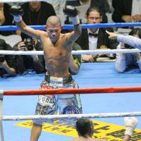 History in the making: Koki Kameda raises his arms after knocking down Alexander Munoz during the final round on Sunday. | KYODO PHOTO