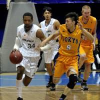 Tough competition: Tokyo Apache guard Kensuke Tanaka, applying pressure on Oita HeatDevils forward Damian Johnson, has made significant improvement this season in the bj-league. | YOSHIAKI MIURA PHOTO