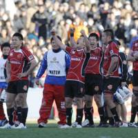 Toshiba Brave Lupus team members celebrate their 17-6 win at the sixth Microsoft Cup tournament Sunday at Chichibunomiya Rugby Stadium. | AKI NAGAO PHOTO