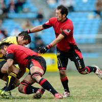 Knight to remember: Sanyo\'s Koliniasi Ryu Holani makes a tackle while teammate Daishi Wakamatsu covers at Prince Chichibu Rugby Memorial Ground on Sunday. | YUKA SHIGA