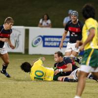 Down and dirty: Hong Kong and Brazil compete during the final of the inaugural Emirates Airlines Cup of Nations on Friday in Dubai. | UNITED ARAB EMIRATES RUGBY FOOTBALL UNION