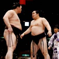 Showdown: Fellow Mongolian sumo wrestlers Asashoryu and Hakuho face off after their bout May 25 on the final day day of the Natsu Basho in Tokyo. | TOKYO APACHE