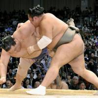 Show of force: Toyonoshima (right) overpowers Kaio at the Kyushu Grand Sumo Tournament on Saturday. | KYODO PHOTO