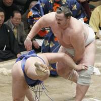 Saturday night special: Baruto flips Tamawashi to the ground at the New Year Grand Sumo Tournament on Saturday. | KYODO PHOTO
