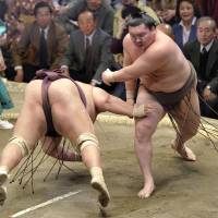 Who\'s next: Hakuho shoves down Miyabiyama on the fifth day of the New Year Grand Sumo Tournament on Thursday. | KYODO