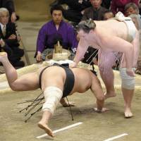 Down you go: Baruto (right) defeats Aminishiki on the sixth day of the New Year Grand Sumo Tournament at Ryogoku Kokugikan. | KYODO