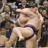 Taking care of business: Yokozuna Hakuho overpowers Chiyotairyu on Friday at the Spring Grand Sumo Tournament in Osaka. | KYODO