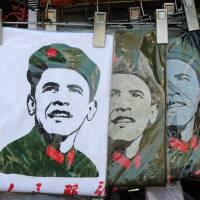 China\'s challenge: T-shirts depicting a Communist Party-styled image of U.S. President Barack Obama are seen on sale at a Beijing shop in May. | AFP-JIJI