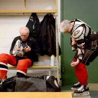 Hit the ice: Clark Torell (left) and Iver Mindel get dressed for a weekly hockey game at The Gardens Ice House in Laurel, Maryland. Every week the group of men, all mostly over the age of 70, get together for a friendly game of hockey in the Gerihatricks league. 'Gerihatricks'
