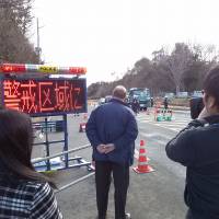 Internal exile: While making a TV documentary in Tohoku last month, Old Nic and the film crew were prevented from going past this policed barrier about 10 km from the Fukushima No. 1 nuclear power plant. The sign reads: \"Danger zone!\" | TAKUMI TOCHIZAWA