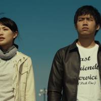 Uncertain future: After her husband dies in an industrial accident, Shiori (Asami Usuda, left) finds her life and her workplace in tatters &#8212; but forms an unexpected bond with Takumi (Takahiro Miura, right), the man responsible for his death. | &#169; 2013 \"Sakuranamiki no Mankai no Shita ni\" Seisaku Iinkai