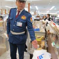 Downing tools: Security guard Naoki Tani points to the spot where former All Black Jerry Collins put down the knives he had carried into the Entetsu department store in Hamamatsu, Shizuoka Prefecture. | SIMON SCOTT