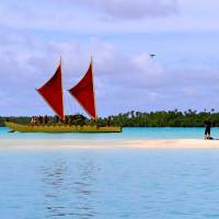 High and dry: A Japanese crew uses a drone in making a film on Aitutaki atoll about traditional oceangoing outrigger canoes like this. Cook Islands paradise isn't plain sailing for all