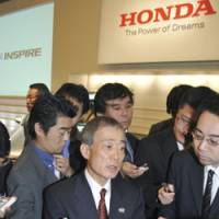 Honda Motor Co. President Takeo Fukui holds a news conference in December in Tokyo. | AP PHOTO