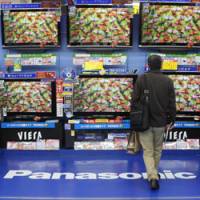 Choices, choices: A man views a Panasonic digital TV at a Tokyo electronics shop last Nov. 7. | BLOOMBERG