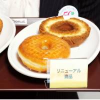 Before and after: Old Mister Donuts products (left) and the new ones are shown to the media Tuesday in the city of Osaka. Duskin Co., operator of the U.S.-founded chain, is changing its donut recipes to cope with sluggish sales. | KYODO
