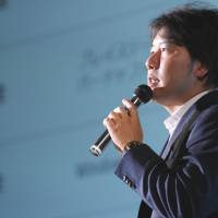 Left behind: Gree Inc. President Yoshikazu Tanaka delivers a keynote speech at Tokyo Game Show 2012 at Makuhari Messe in Chiba on Sept. 20. Young Gree chief loses $2.6 billion to smartphone boom