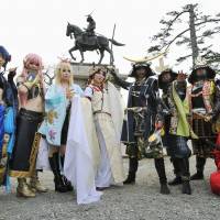 Just be \"cos\": \"Cosplayers\" from Japan and abroad pose Wednesday for a tourism-promotion photo  at the site where Sendai Castle once stood. | KYODO