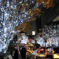 All aglow: Trees at the Roppongi Hills complex in Minato Ward, Tokyo, glitter with white and blue LED lights on Dec. 13. Below, a garden at nearby Tokyo Midtown is covered with blue LED lights. | SATOKO KAWASAKI PHOTOS