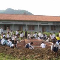 Base for hope: Children build a base for their new school\'s flagpole in Pailin Province, Cambodia. | COURTESY OF AMATAK HOUSE OF CAMBODIA