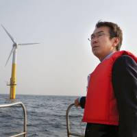 Tailwinds: Environment Minister Nobuteru Ishihara inspects an offshore floating wind turbine on March 9 off the island of Kabashima in Nagasaki Prefecture. | KYODO