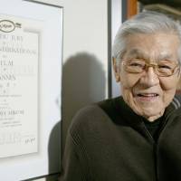 In recognition: Actor Rentaro Mikuni stands next to his 1987 Cannes International Film Festival award in this file photo taken in 2010 in Tokyo. | KYODO