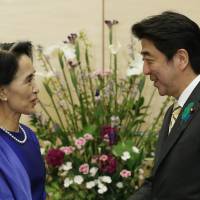Hi: Nobel laureate and Myanmar opposition leader Aung San Suu Kyi and Prime Minister Shinzo Abe exchange greetings ahead of their meeting at the prime minister\'s office on Thursday. | AFP-JIJI