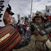 Cut and thrust: Men dressed as samurai fight in a re-enactment of the 16th-century Battle of Kawanakajima, on Sunday in Fuefuki, Yamanashi Prefecture. | AP