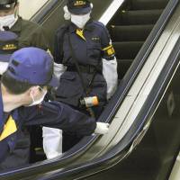 Hands off: Police examine a damaged escalator at JR Akihabara Station in Tokyo that injured six people on Wednesday morning. | KYODO
